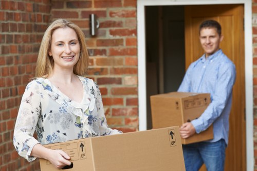 Careful packing of household items by a packing team in Hanworth